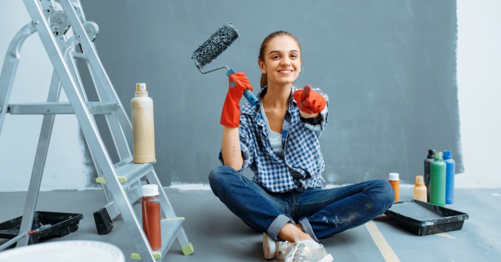 A painter pointing at the screen, symbolizing the urgency of hiring Cabinet Refinishing North Bay for residential house painting.